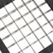 A white square metal dicing blade assembly with black squares.