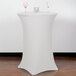 A white Snap Drape Contour table cover on a round bar height table with two glasses on it.