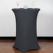 A Snap Drape charcoal spandex table cover on a round bar table with two glasses on it.