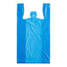 A blue plastic T-shirt bag with an embossed pattern and no handles.