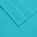 A close up of a teal poly/cotton fabric.
