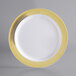 A white plastic Visions plate with a gold lattice design.