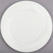 A Visions Wave ivory plastic plate with a circular pattern.