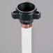A black and white Hoshizaki water pipe with a black plastic sleeve.