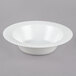 A white Visions plastic bowl with wavy lines on the edge.