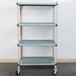 A MetroMax Q shelving cart with rubber casters holding three metal shelves.
