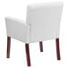 A Flash Furniture white leather reception chair with mahogany legs.