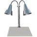 A Hanson Heat Lamps chrome carving station with two lamps over a white surface.