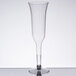 A Visions clear plastic champagne flute on a table.