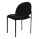 A Flash Furniture black fabric stackable side chair with metal legs.