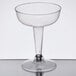 A Visions clear plastic champagne glass with a stem.
