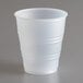 A Dart Y5 Conex translucent plastic cup on a gray surface.