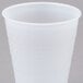 A Dart translucent plastic cup on a gray surface.