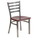 A Clear-Coated metal restaurant chair with a mahogany wood seat and back.