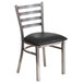A Flash Furniture metal restaurant chair with a black vinyl cushion on the seat.