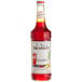 A Monin Premium Grenadine Flavoring Syrup 750 mL bottle filled with red liquid.