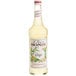 A 750 mL bottle of Monin ginger syrup with a label.