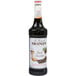 A white labeled Monin bottle of dark liquid, Monin Premium Dark Chocolate Flavoring Syrup.