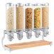 A Cal-Mil beechwood cereal dispenser with five canisters of cereal.