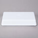 A white rectangular melamine tray with a blue circle on the rim.