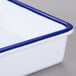 A white melamine serving tray with a blue rim and handles.