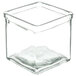 A clear square glass jar with a lid on a white background.