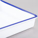 A white melamine tray with a blue rim.