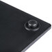 A black rectangular melamine serving platter with a faux slate texture and a round button in the corner.