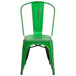A green metal Flash Furniture restaurant chair with a vertical slat back.