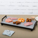 A Cal-Mil rectangular faux cement serving platter with meat and vegetables on a table.