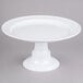 A white plate on a round white pedestal stand.