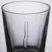 A close up of a clear Spiegelau whiskey glass with a small hole in it.