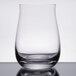 A clear Spiegelau whiskey tumbler on a white background.