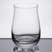 A close up of a clear Spiegelau whiskey tumbler filled with a clear liquid.