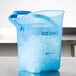 A blue plastic container with ice in it.