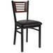 A black BFM Seating metal side chair with a walnut wood back and black vinyl seat.