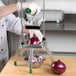 A chef using a Garde XL vegetable dicer to chop a red onion.