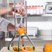 A person using a Garde 8 Section Fruit Wedge Cutter to cut an orange.