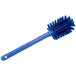A blue Carlisle Sparta Spectrum bottle cleaning brush with bristles.