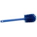 A Carlisle blue bottle cleaning brush with bristles.