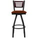 A BFM Seating metal bar stool with a mahogany wood back and brown vinyl seat.