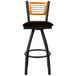 A BFM Seating bar stool with a black metal frame, natural wooden back, and dark brown swivel seat.