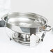 A Vollrath stainless steel water pan with a silver handle in a chafer stand.
