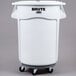 A white Rubbermaid Brute trash can with wheels.
