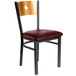 A BFM Seating black metal side chair with a wooden back and burgundy vinyl seat.