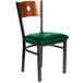 A BFM Seating black metal side chair with a green vinyl seat.