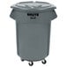 A Rubbermaid grey trash can with wheels and a lid.