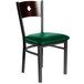 A BFM Seating black metal side chair with a walnut back and green vinyl seat.