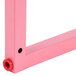 A pink metal Carnival King wheel frame with a hole in the middle.