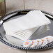 A silver tray with a stack of Hoffmaster white linen-feel guest towels.